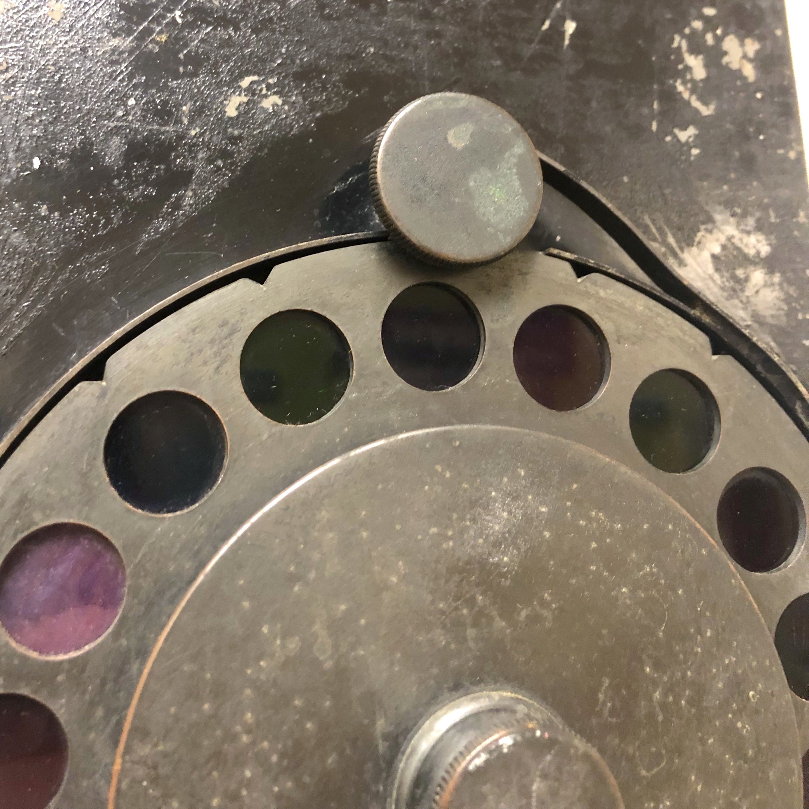 Grey dial with holes revealing various colours around the edge